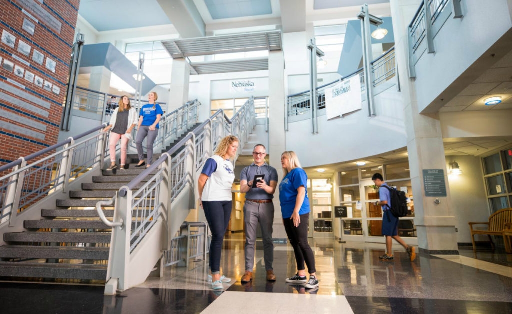 students speaking in campus building